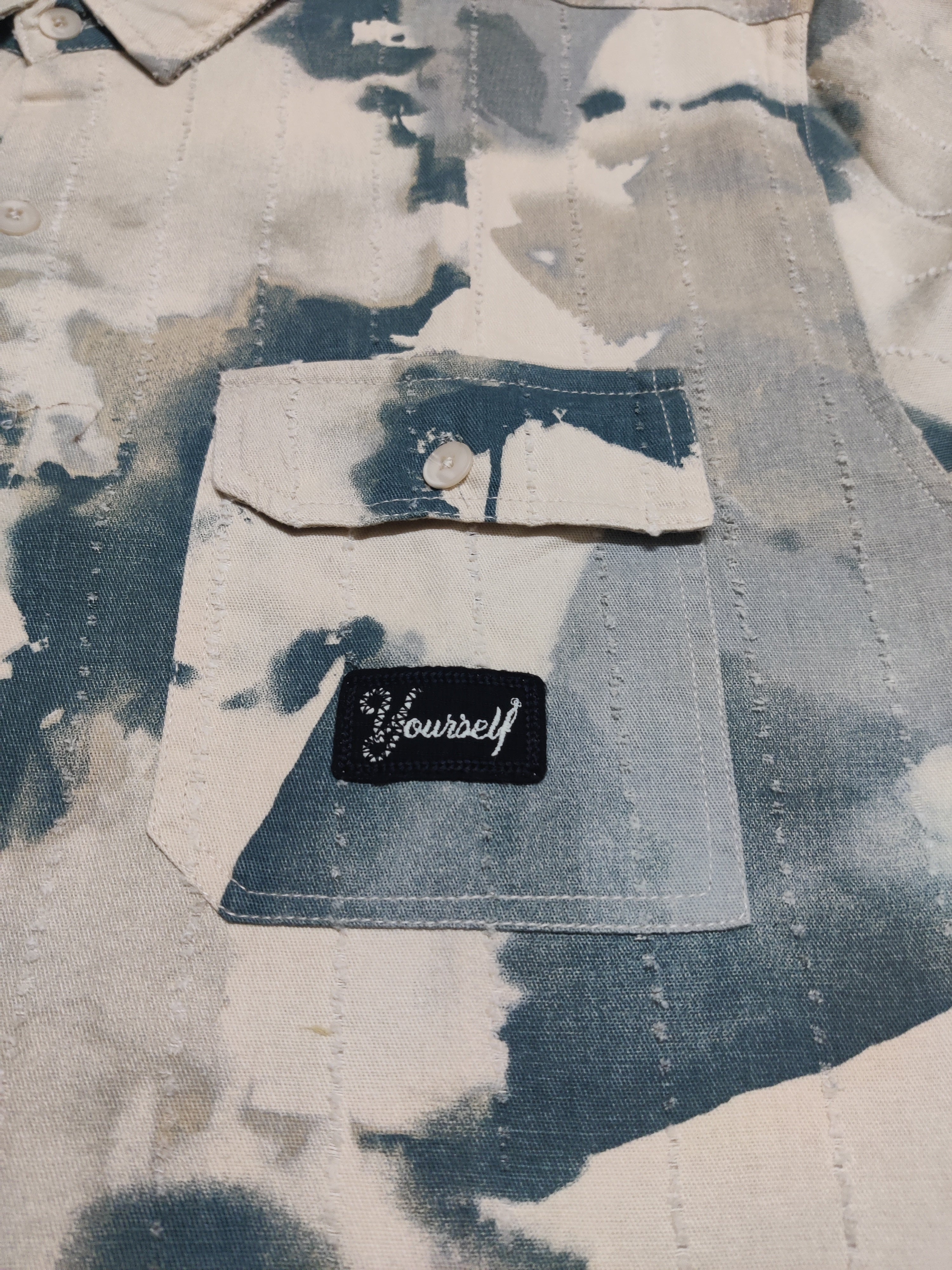Denim jacket with a patch on a textured background