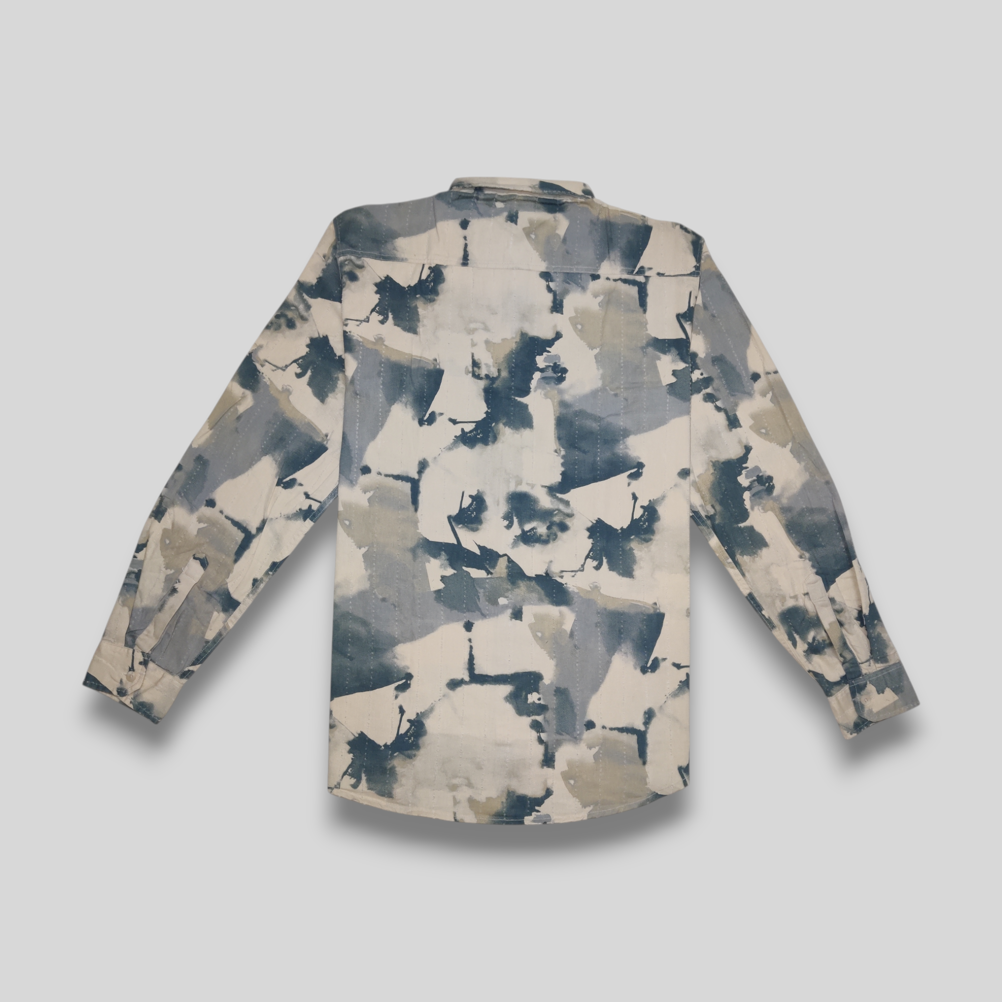Camouflage-patterned shirt on a light gray background