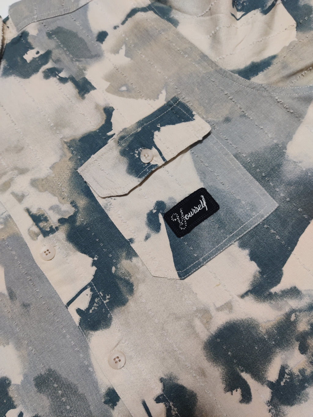 Denim jacket with a brand label on a textured background
