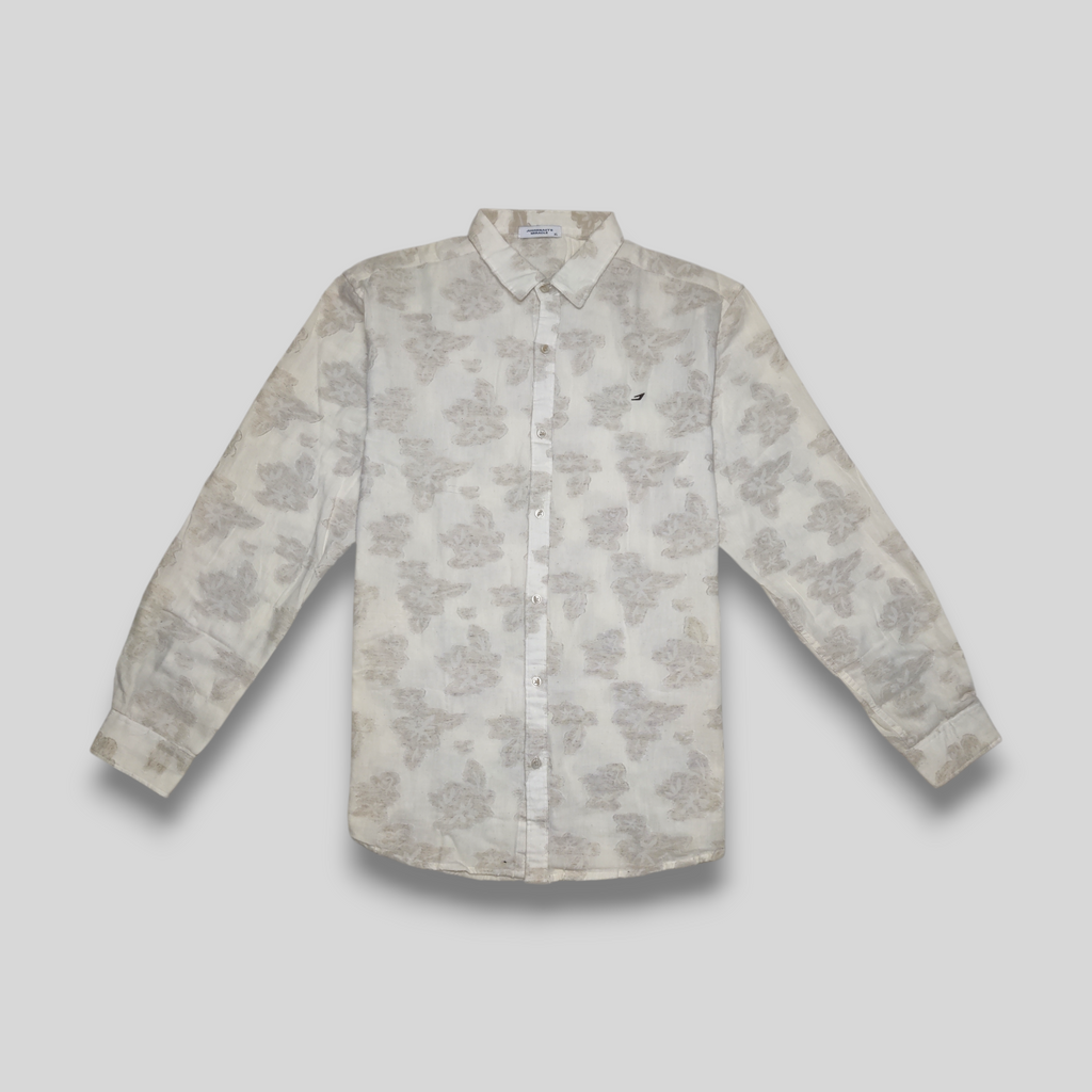 A beige linen shirt with embossed flower pattern, displayed against a neutral background