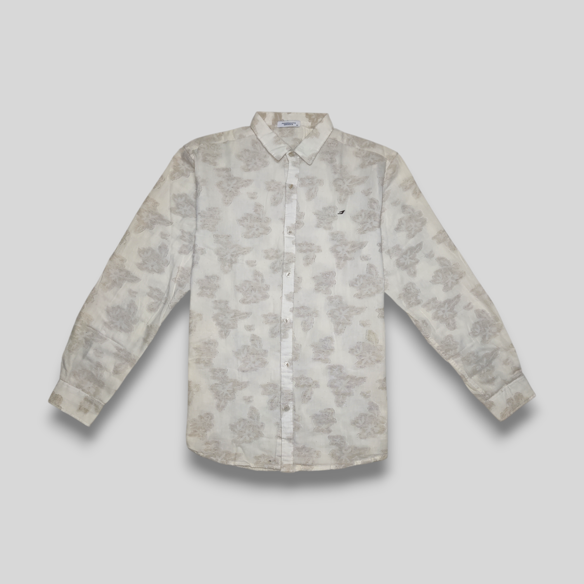 A beige linen shirt with embossed flower pattern, displayed against a neutral background