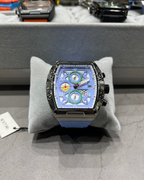 Luxury watch with a unique face on a gray cushion, blurred background