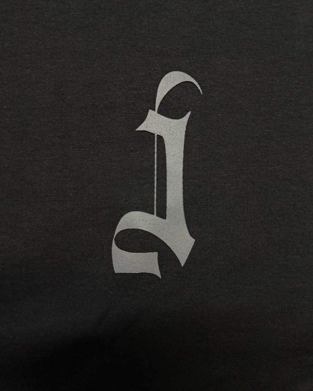 Grey HD Printed Decorative Gothic letter 'J' in a stylized font on a black background