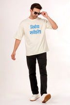 Man wearing a white t-shirt with blue sanskrit text and black pants on a white background