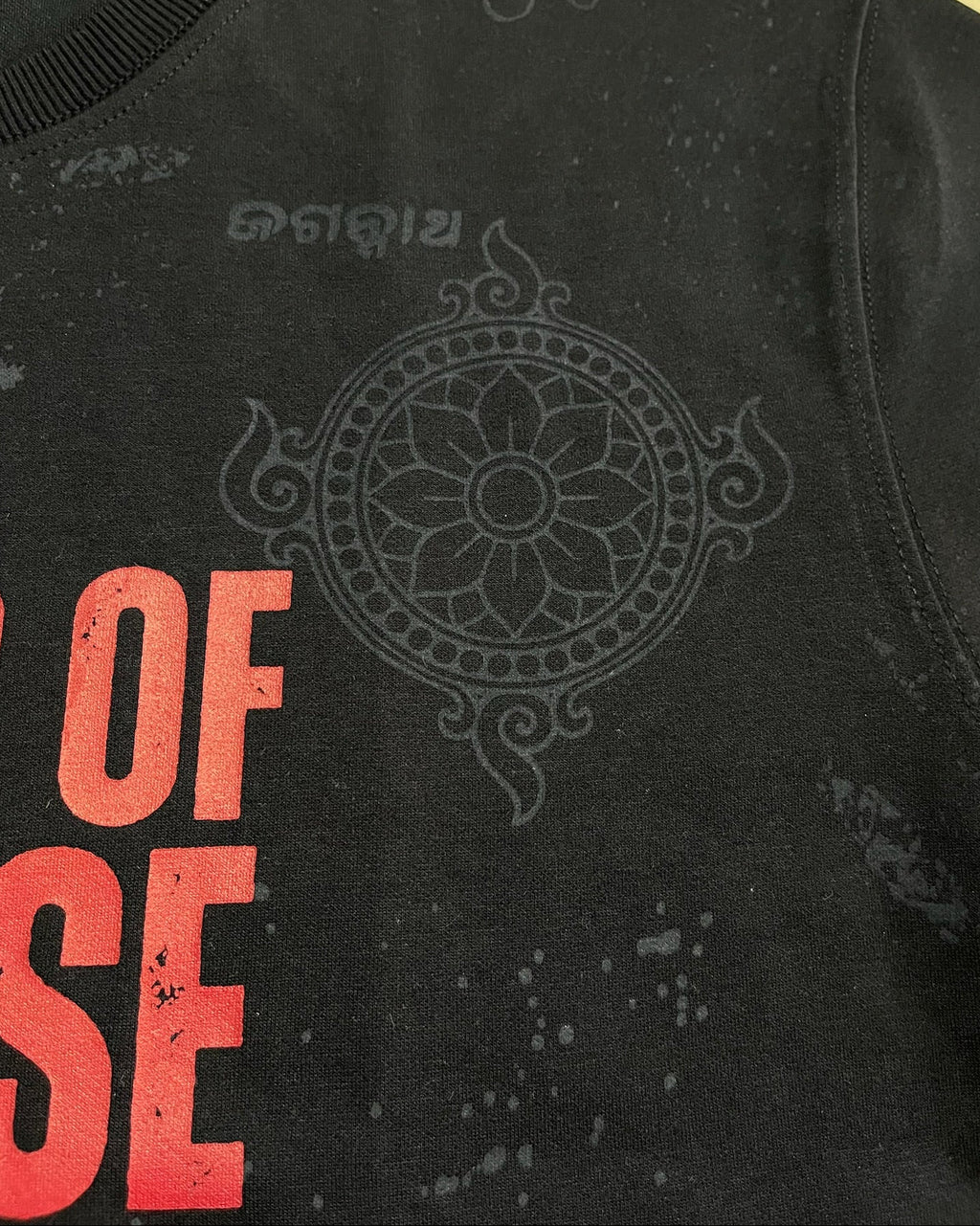 Black tshirt with red text and decorative design on a yellow background