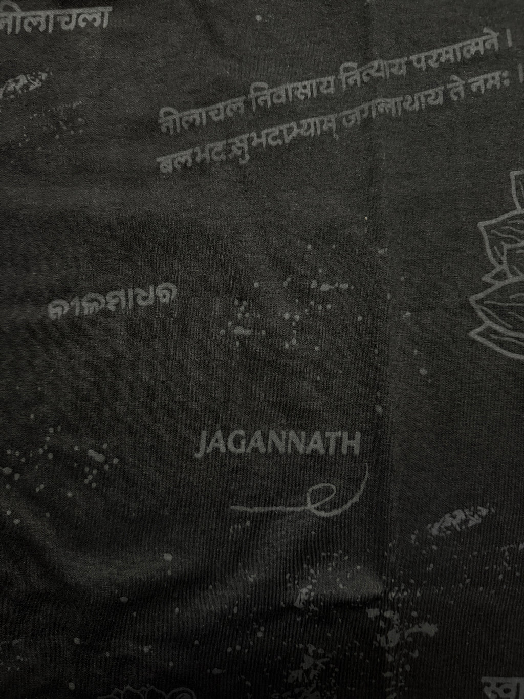 Black fabric with white text and 'Jagannath' branding on a dark background