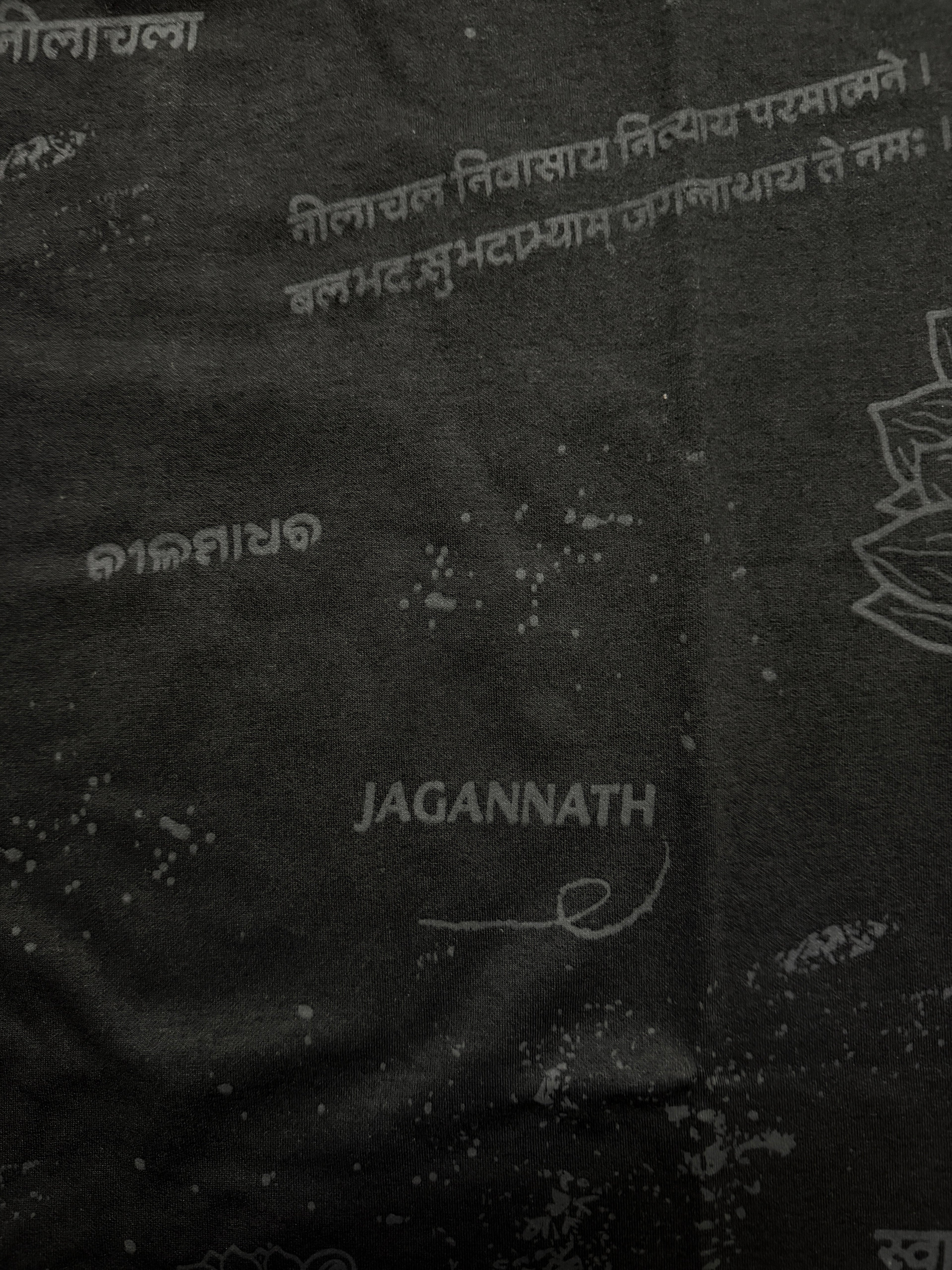 Black fabric with white text and 'Jagannath' branding on a dark background