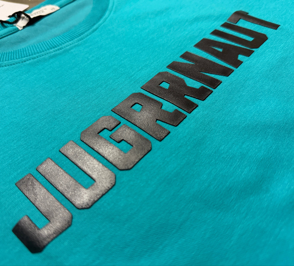 Turquoise sweatshirt with black 'Jugrrnaut' text on a plain background