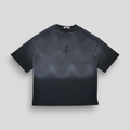 A black oversized T-shirt with a spray-painted front and back gradient and a 3D embroidered 'J' logo in the center.