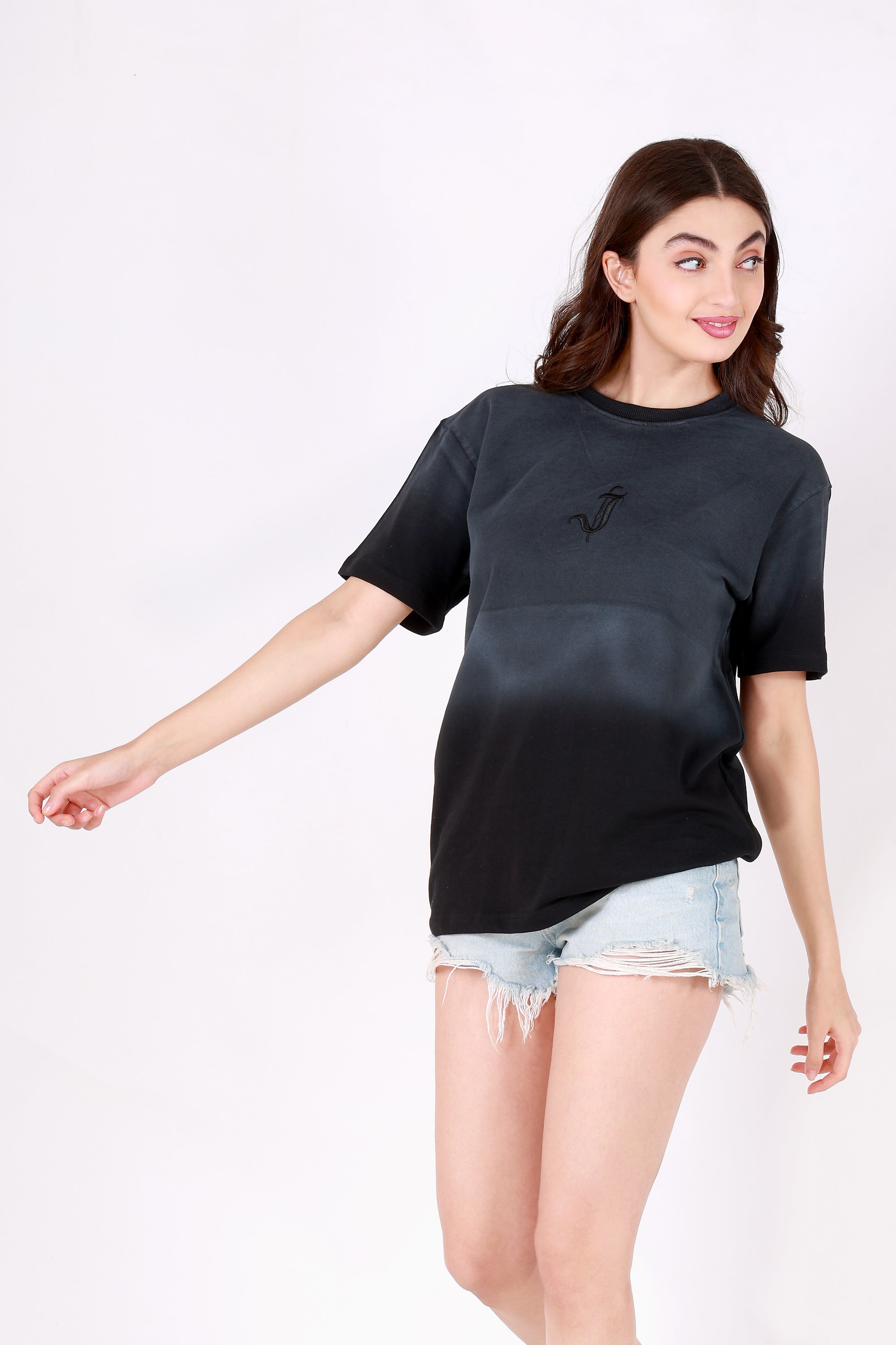 Woman wearing a black t-shirt with a logo on a white background