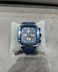 Blue watch on a gray cushion with a marble background