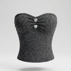 Black strapless top with heart-shaped embellishments on a light gray background