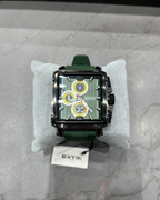 Green watch with a detailed face on a gray surface, branded 'EXTRI'.