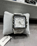 Watch on a gray cushion with 'EXTRI' tag in the background