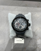 Black wristwatch with visible brand name on a marble surface
