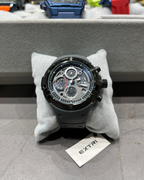 Luxury watch on a gray cushion with 'EXTRI' branding in the background
