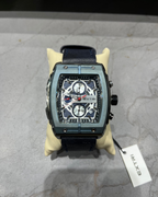 Luxury watch with a detailed face on a gray surface, featuring the brand 'Extri'.