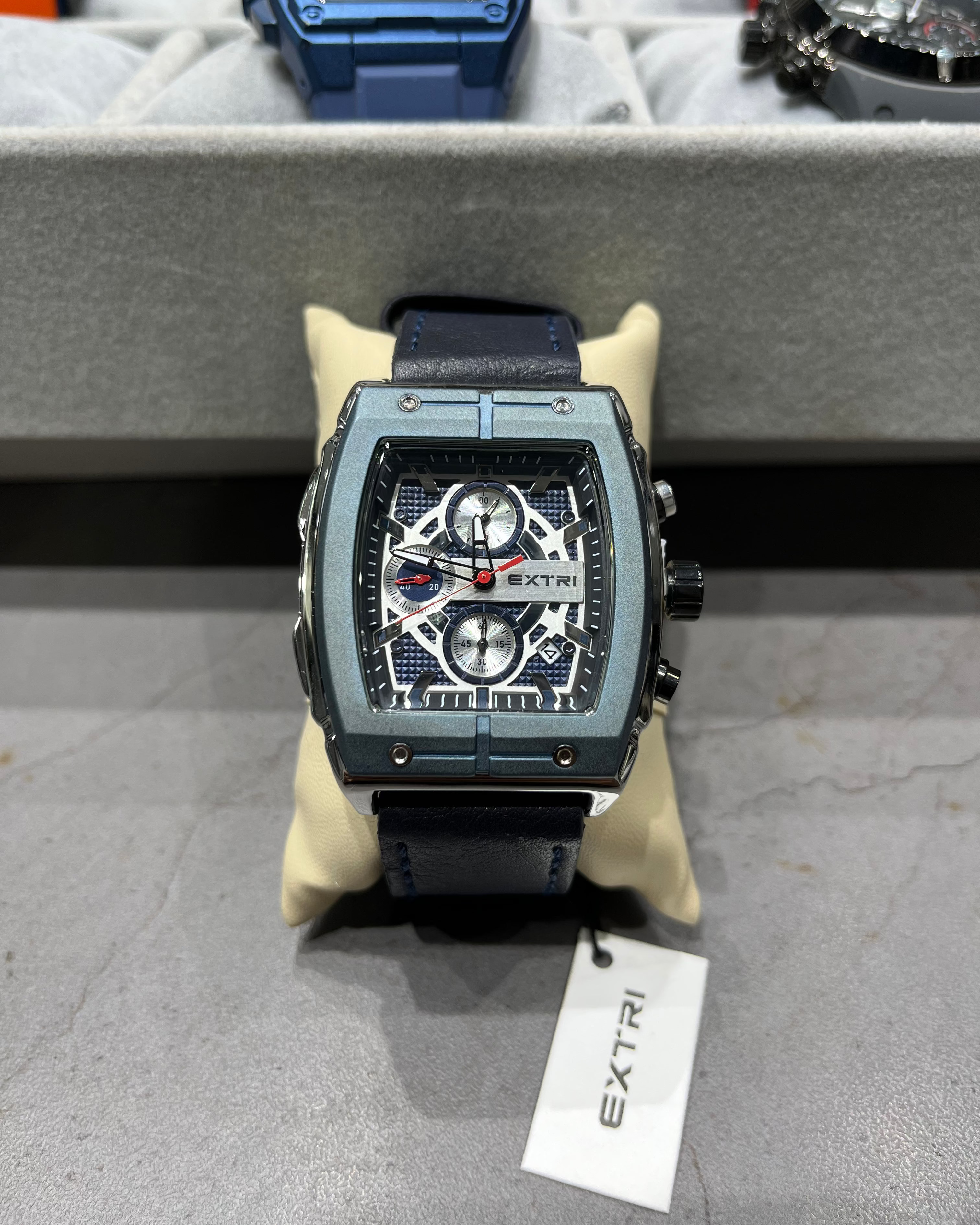 Luxury watch with visible brand name on a display stand