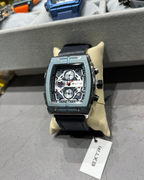 Luxury watch with a visible brand tag on a gray surface