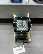 Luxury watch with intricate design on a gray surface, branded 'EXTRI'.