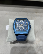 Blue watch on a gray cushion with a neutral background