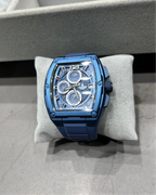 Blue watch on a gray cushion with a blurred background