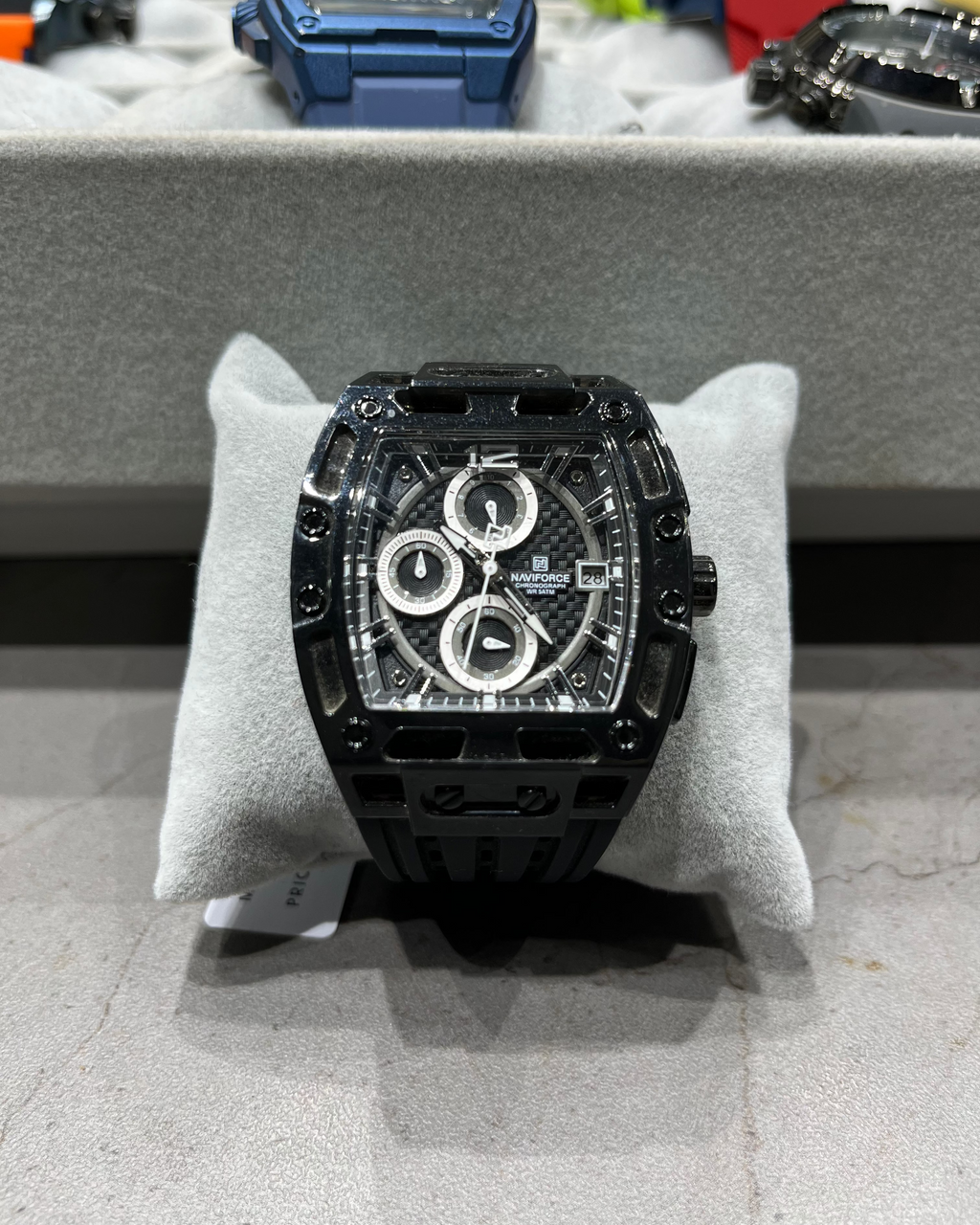 Luxury black watch on display with a gray background
