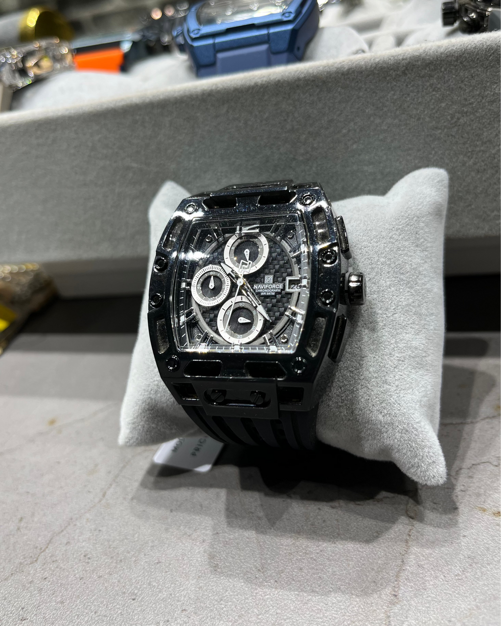 Black watch on a gray cushion with a blurred background