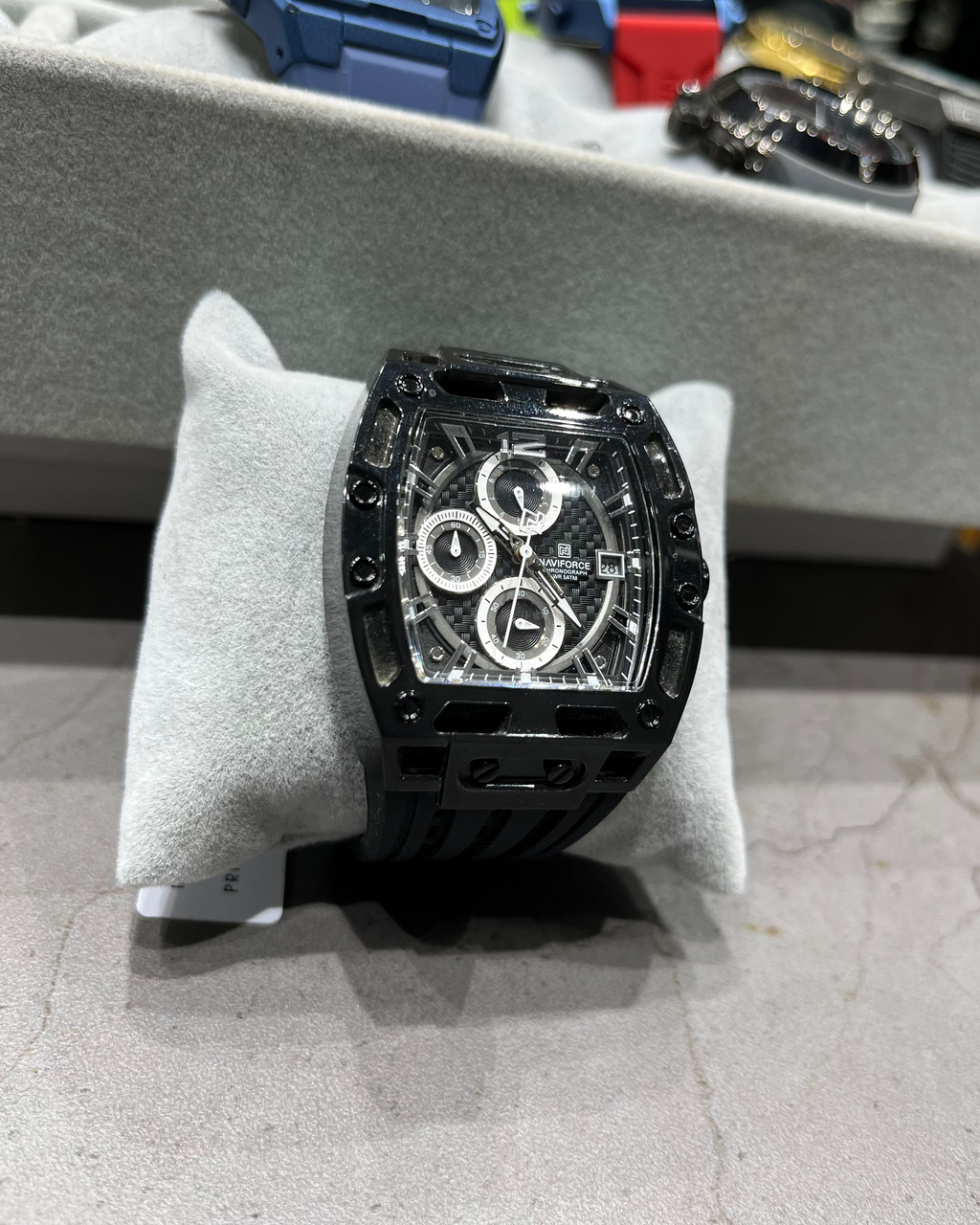 Black watch on a display stand with blurred background