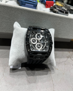 Black watch on a display stand with blurred background