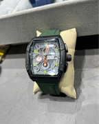 Luxury watch with green strap on a display stand
