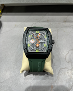 Wristwatch with green strap on a gray surface