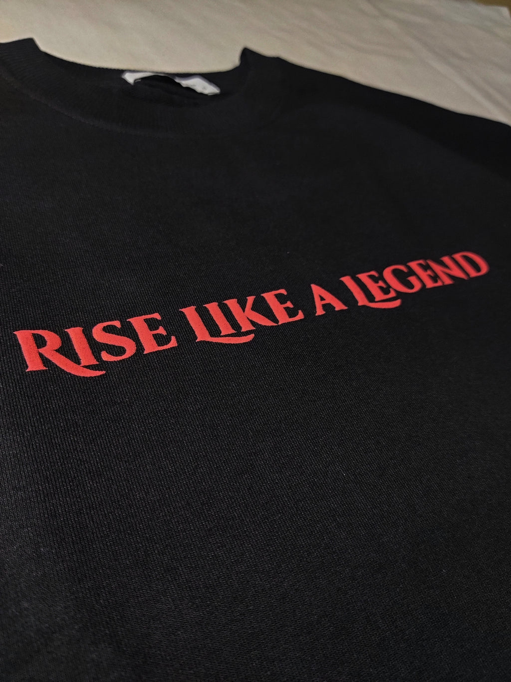 Black sweatshirt with 'Rise Like a Legend' text in red on a plain background