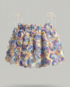 Colorful ruffled skirt on a gray background