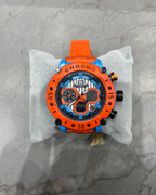 Orange and black watch on a gray marble surface