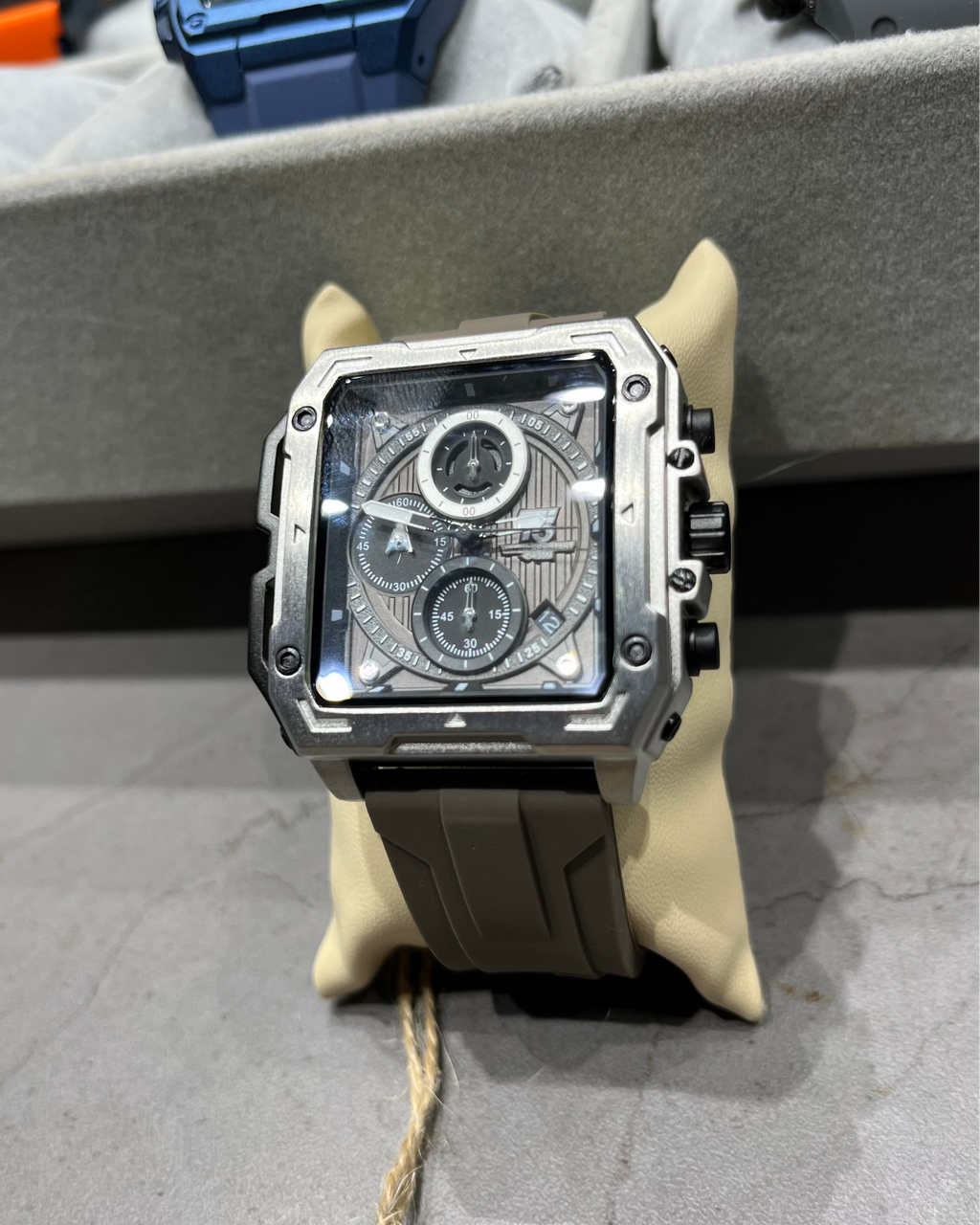 Luxury watch with intricate design on a stand in a display case.