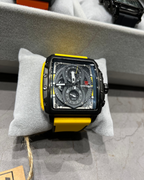 Watch with a yellow strap on a gray surface